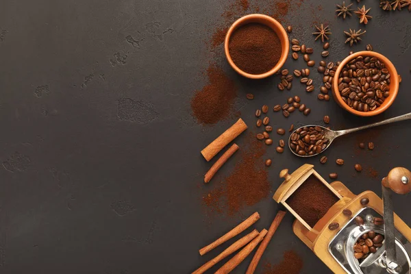 Top view on old coffee mill, scattered beans and spices, background with copy space — Stock Photo, Image