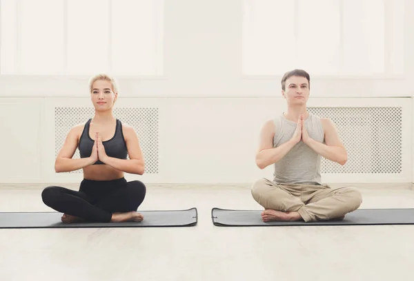 Ungt par öva yoga som sitter i lotus pose — Stockfoto