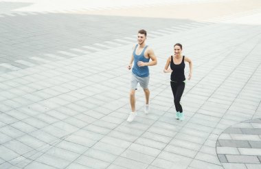 Genç kadın ve şehir kopya alanı içinde koşan adam