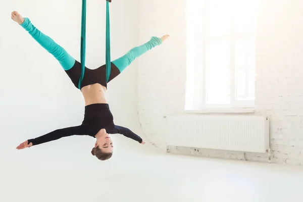 Woman practicing fly yoga over white background