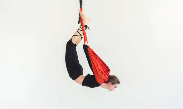 Woman practicing fly yoga over white background — Stock Photo, Image