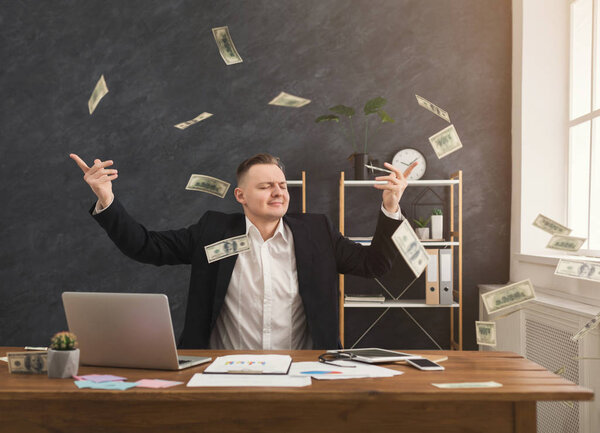 Financier man throwing out dollars in office