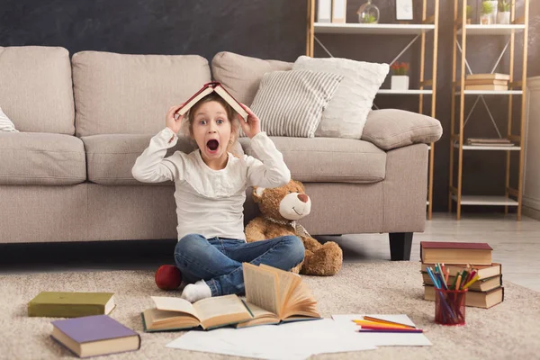 Niña con libro y su juguete favorito en casa —  Fotos de Stock