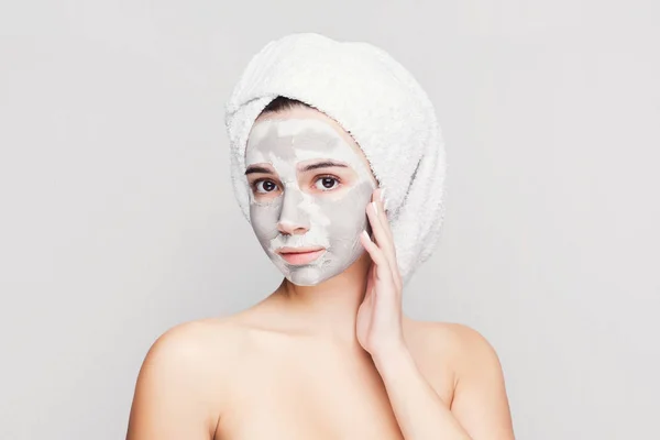 Beautiful girl with applied clay mask at white background — Stock Photo, Image