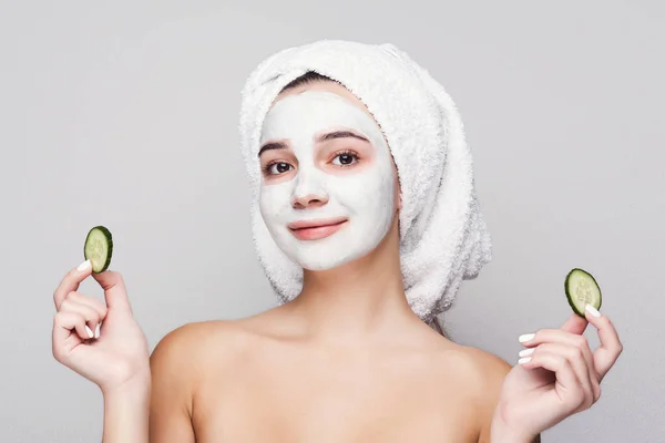 Beautiful girl with applied clay mask at white background — Stock Photo, Image