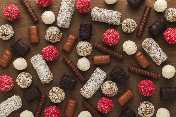 Wooden desktop with assortment of sweets — Stock Photo, Image