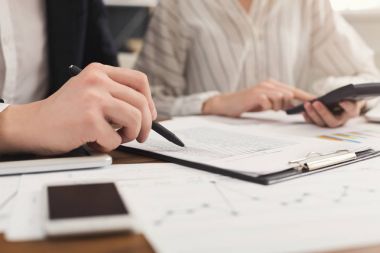 Belgelerin incelenmesi ve hesap makinesini kullanarak iş arkadaşları