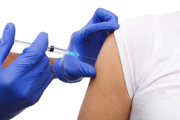 Black male hand in blue gloves holding a plastic syringe — Stock Photo, Image