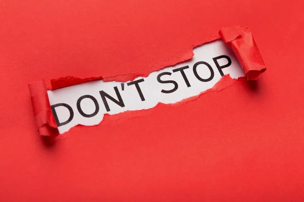 Dont Stop Phrase platzt aus zerrissenem roten Papier — Stockfoto