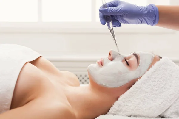 Mulher recebe máscara facial por esteticista no spa — Fotografia de Stock