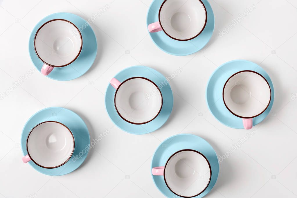 Elegant porcelain blue and pink cups on abstract background