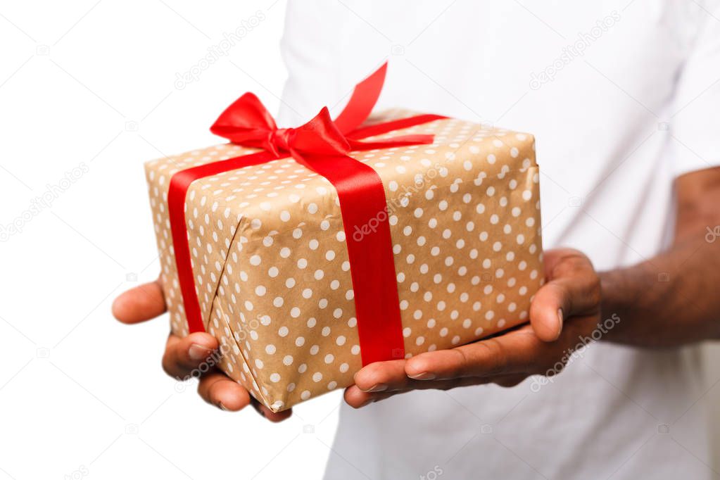 Black man holding gift box isolated on white background
