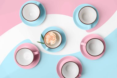 Elegant porcelain blue and pink cups on abstract background clipart