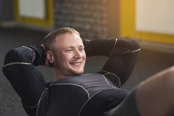 Young man fitness workout, sit-up crunches for abs