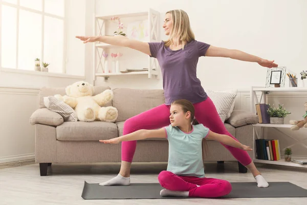 Young woman and child daughter training at home — Stock Photo, Image