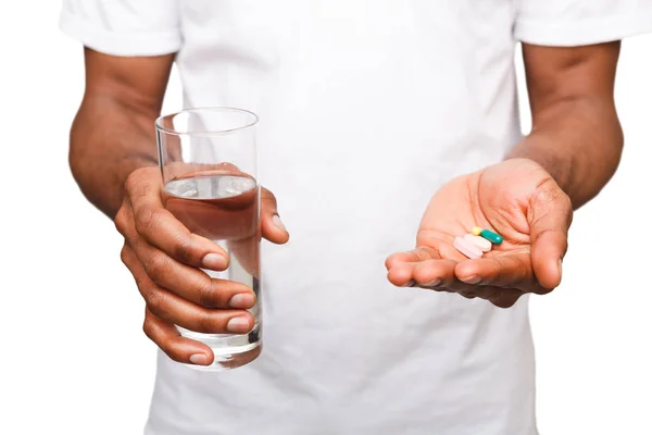 Black man holding a pill isolated on white background — Stock Photo, Image