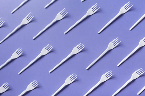 Top view on plastic forks on violet background — Stock Photo, Image