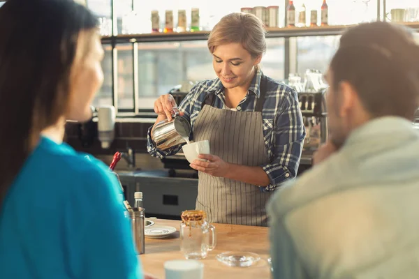 Досвідчений усміхнений бариста робить каву клієнтам — стокове фото