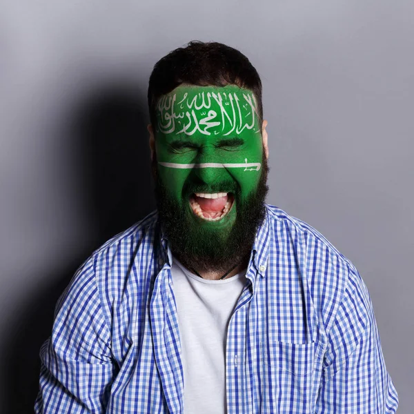 Young man with Saudi Arabian flag painted on his face — Stock Photo, Image