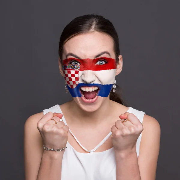 Young woman with Croatia flag painted on her face