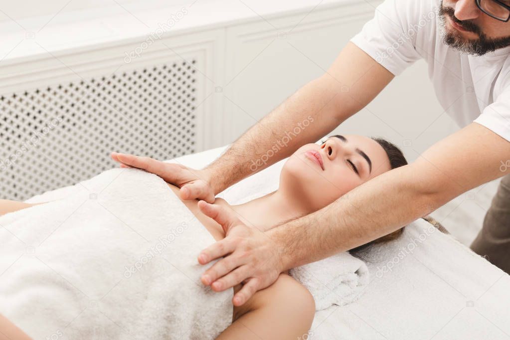 Woman enjoying professional massage at spa