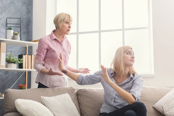 Portrait of angry adult woman and daughter at home — Stock Photo, Image