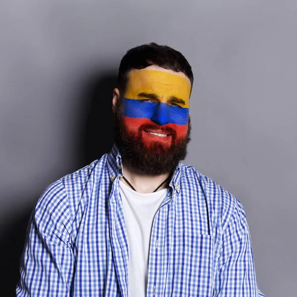 Young man with Columbia flag painted on his face — Stock Photo, Image