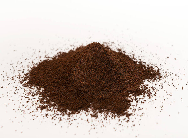 Ground coffee pile isolated on white background