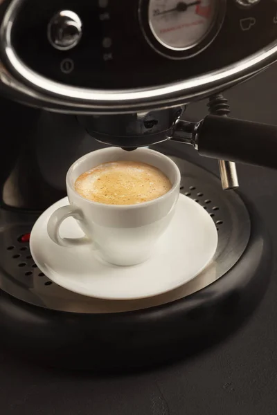 Brewing coffee in professional machine, closeup