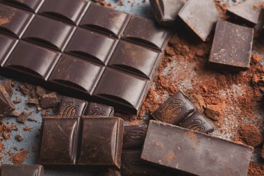 Çikolata parçaları ve gri arka plan üzerine kakao ezilmiş