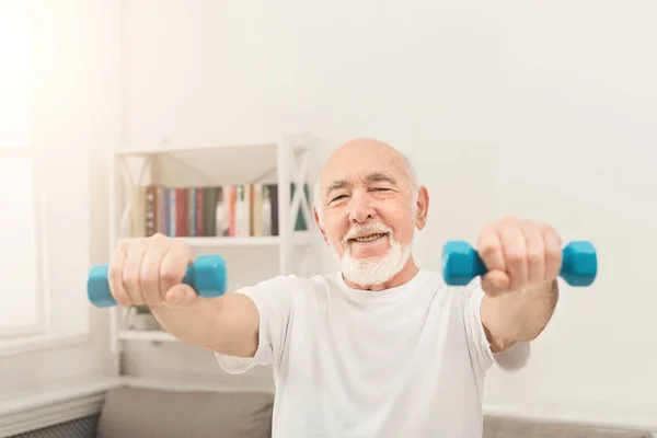 Homem sênior fazendo exercício com halteres — Fotografia de Stock