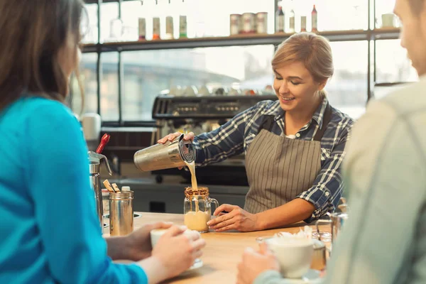 Experienced smiling barista giving master class