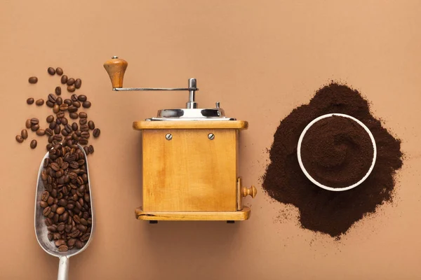 Retro coffee grinder, beans and powder on old table, top view — Stock Photo, Image