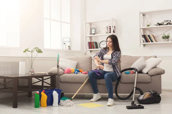 Woman with cleaning equipment ready to clean room