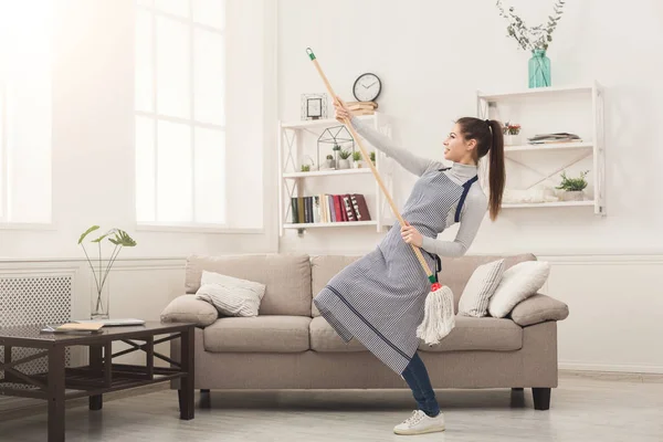 Mutlu kadın eve paspas ile temizlik ve having fun — Stok fotoğraf