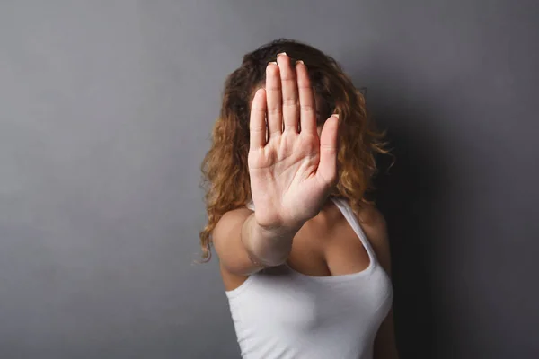 Young woman covering her face with palm — Stock Photo, Image