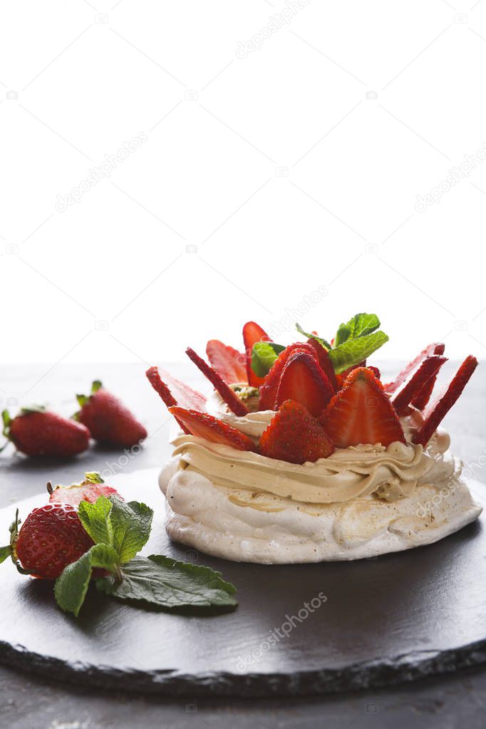 Delicious Anna Pavlova meringue cake with strawberry on white background