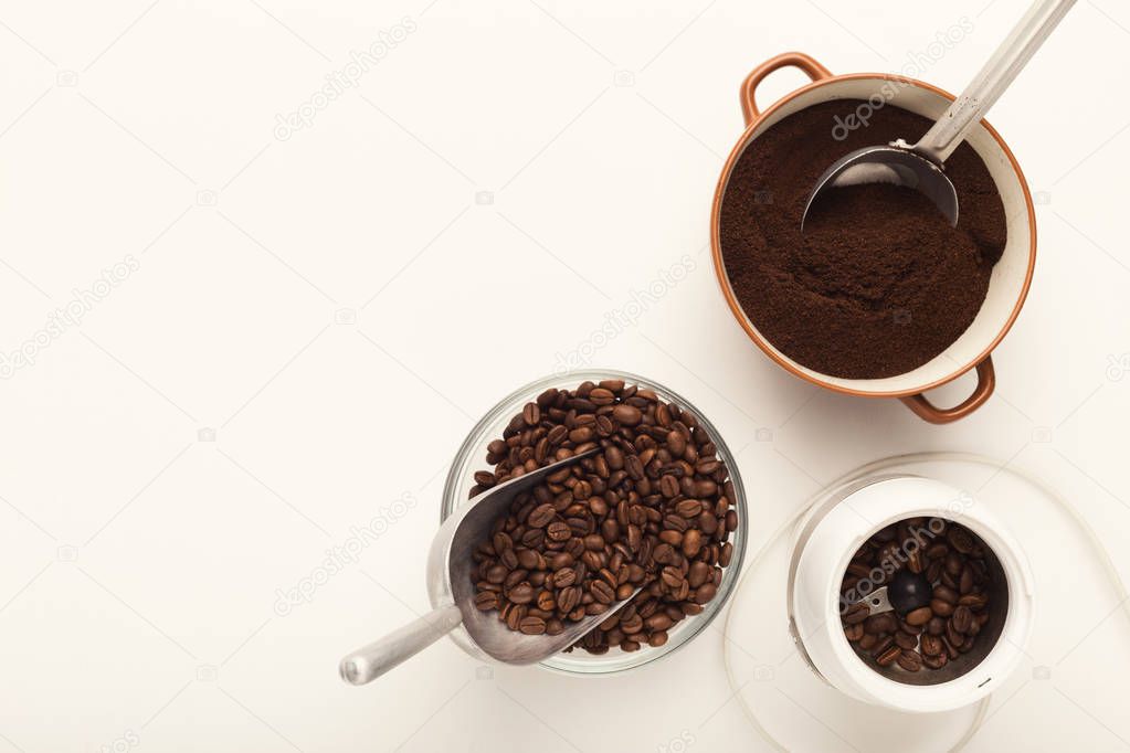 Top view on coffee beans and power bowls isolated on white