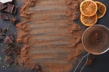 Aromatic cocoa powder scattered over black background clipart