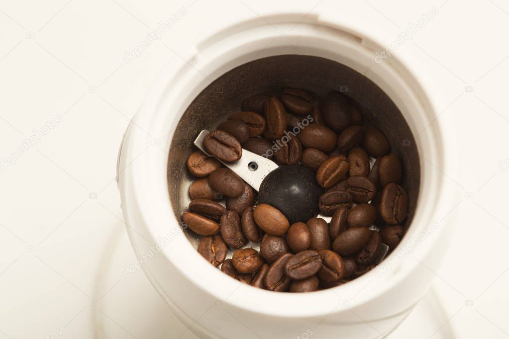 Small electric coffee mil with roasted beans