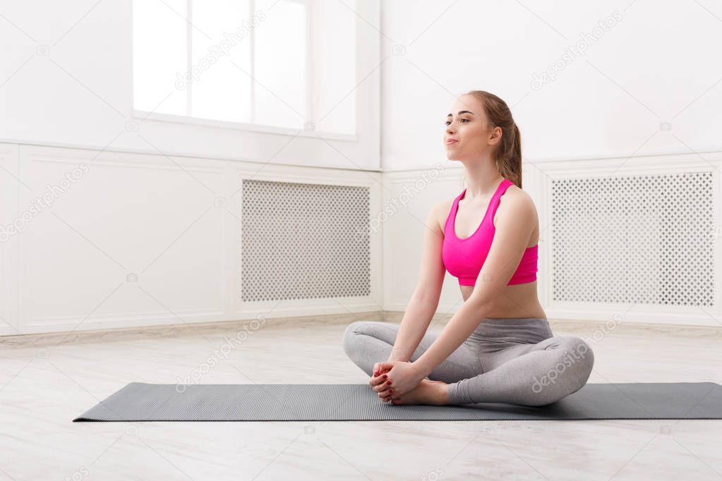 Fitness woman stretching at white background indoors