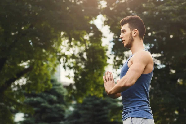 Meditating man with praying hands outdoors — Stock Photo, Image