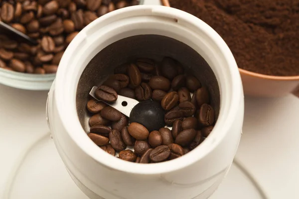 Small electric coffee mil with roasted beans — Stock Photo, Image
