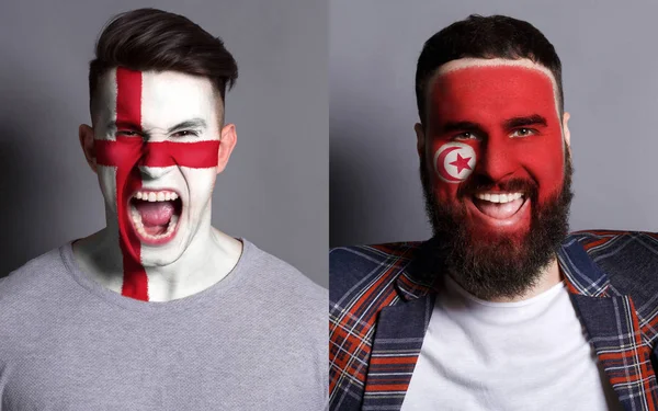Emotionele voetbalfans met geschilderde vlaggen op gezichten — Stockfoto