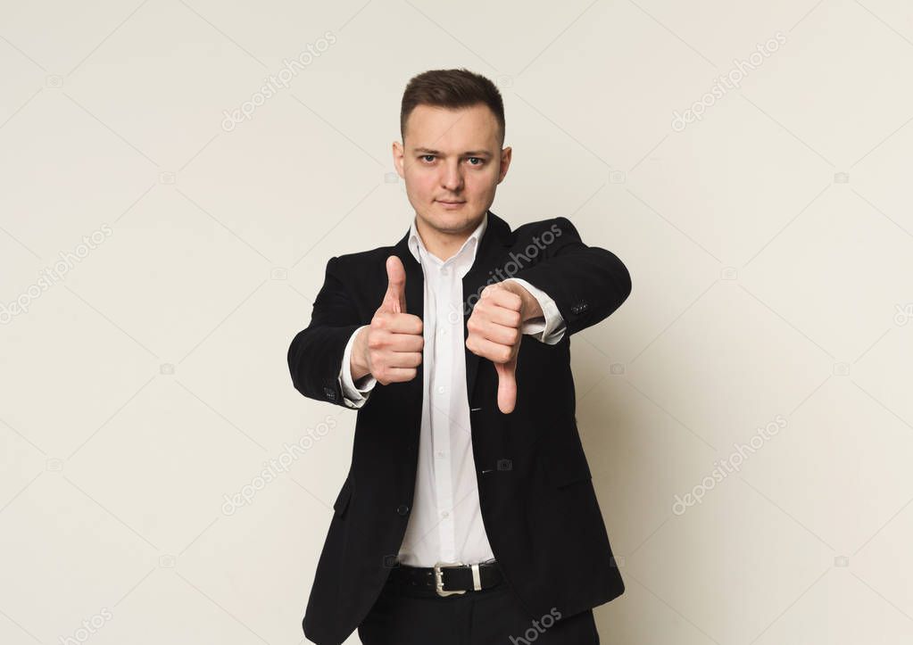 Businessman making good-bad sign