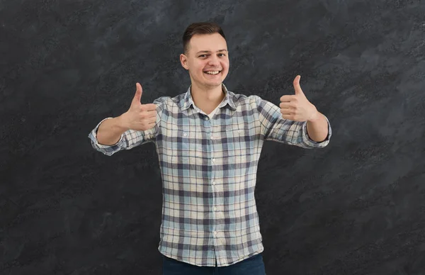 Young happy man with thumb up portrait