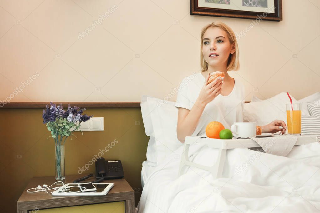 Beautiful young woman having breakfast