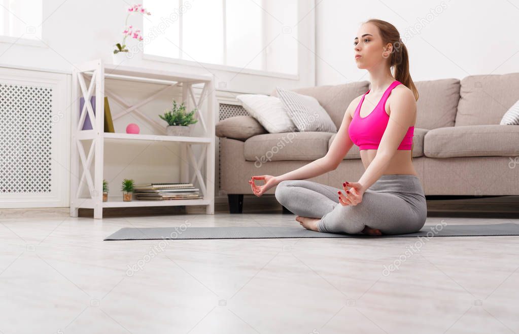 Woman training yoga in lotus pose