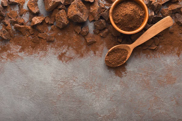 Crushed chocolate pieces on gray background, top view — Stock Photo, Image