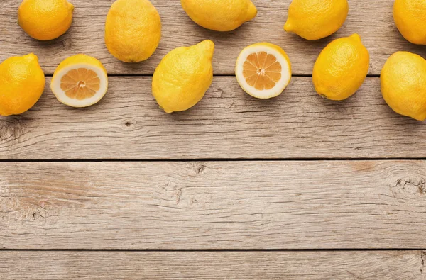 Variety of ripe citruses on wooden background